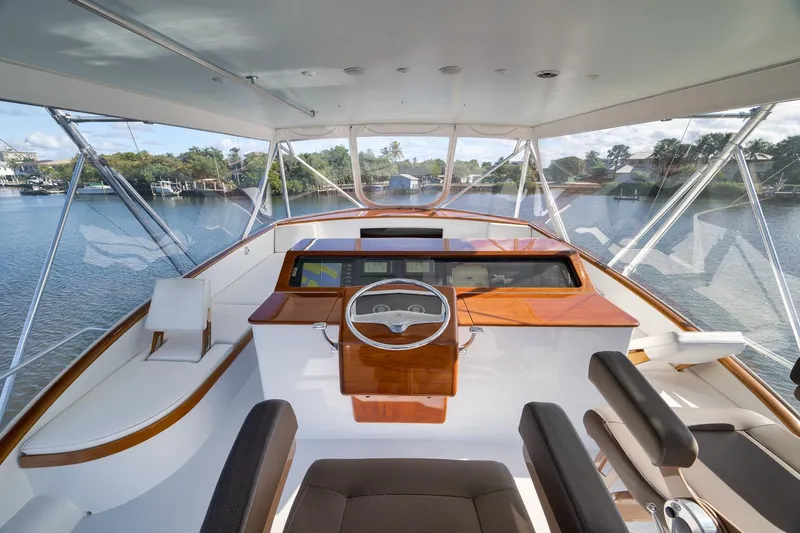 Slide: The Image of Cockpit of 1993 Merritt Sportfish boat with steering wheel and navigation equipment. - 37