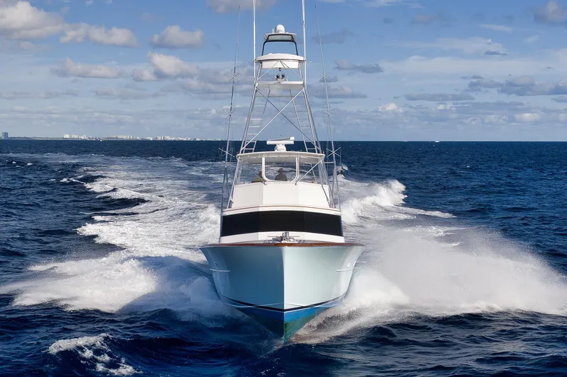 Slide: The Image of 1993 Merritt Sportfish yacht cruising on open ocean under blue sky. - 4