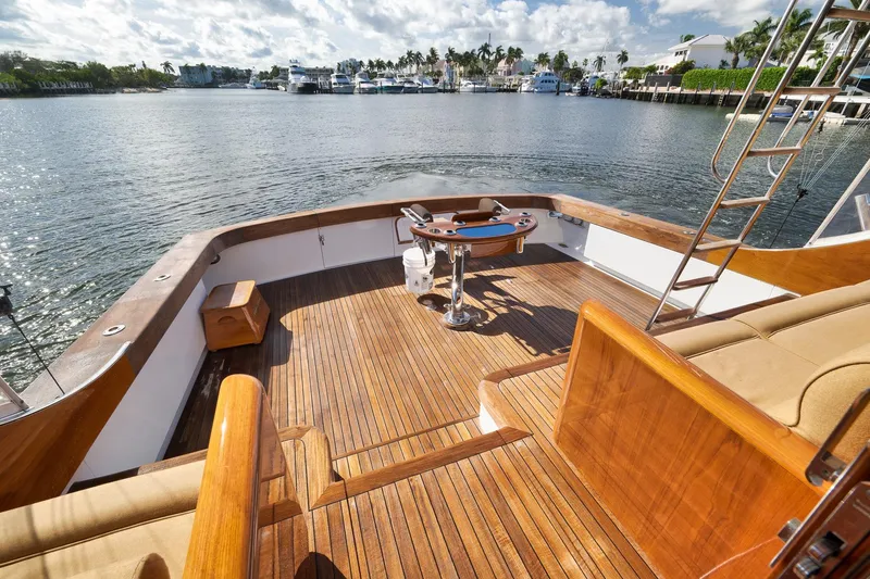 Slide: The Image of 1993 Merritt Sportfish boat deck with wooden flooring, overlooking a serene waterfront. - 43