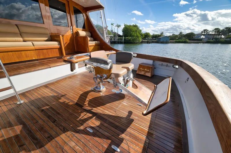 Slide: The Image of Luxurious 1993 Merritt Sportfish yacht deck with polished wood and fishing chair. - 45