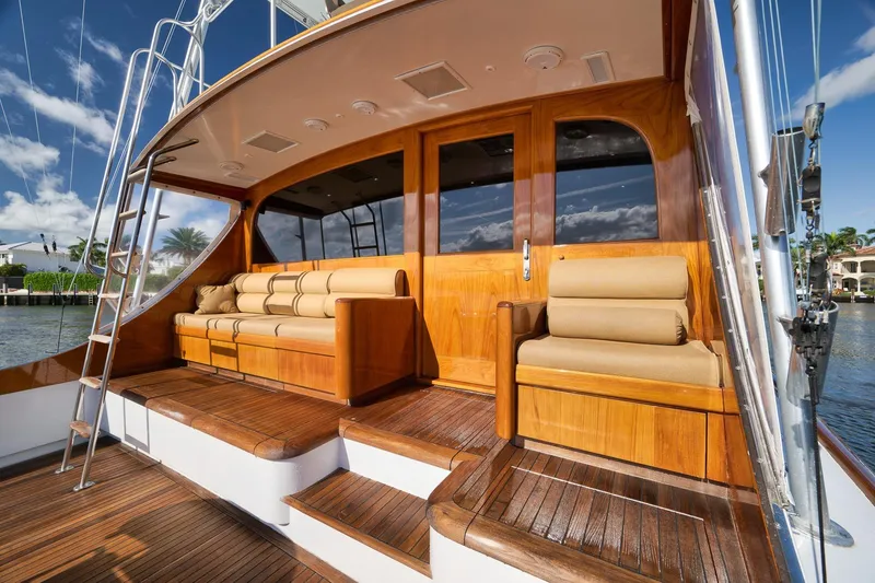Slide: The Image of Luxurious 1993 Merritt Sportfish yacht with elegant wooden deck and seating area. - 46