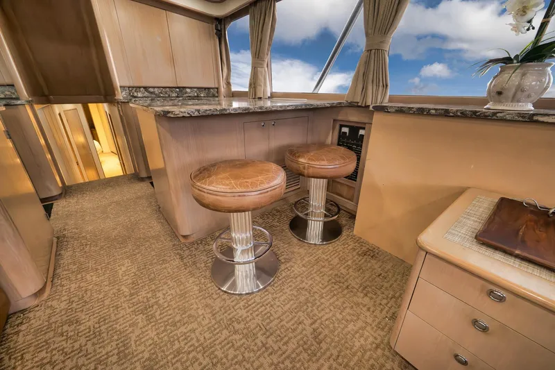 Slide: The Image of Luxurious 1993 Merritt Sportfish yacht interior with bar stools and elegant decor. - 49