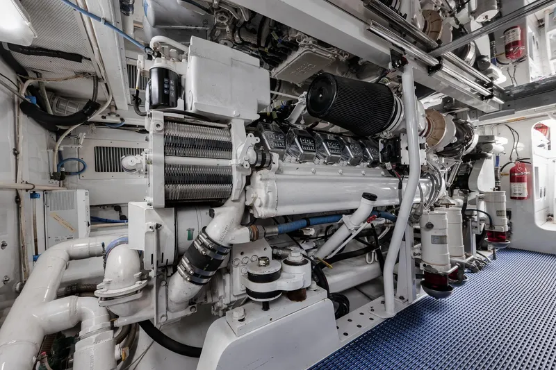 Slide: The Image of Engine room of a 1993 Merritt Sportfish boat, showcasing complex machinery and equipment. - 12