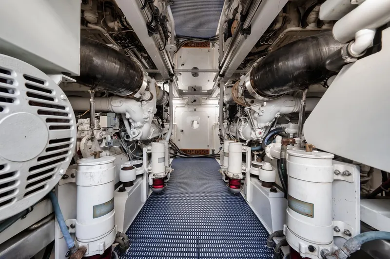Slide: The Image of Engine room of a 1993 Merritt Sportfish boat, showcasing mechanical components and systems. - 14