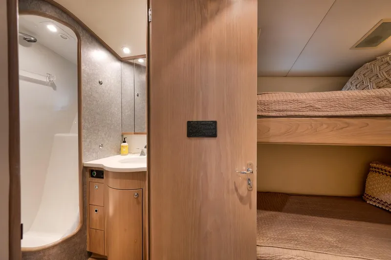 Slide: The Image of Interior of 1993 Merritt Sportfish yacht with bathroom and bunk beds. - 19