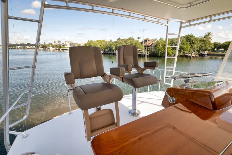 Slide: The Image of 1993 Merritt Sportfish boat helm with chairs overlooking serene waterway. - 28