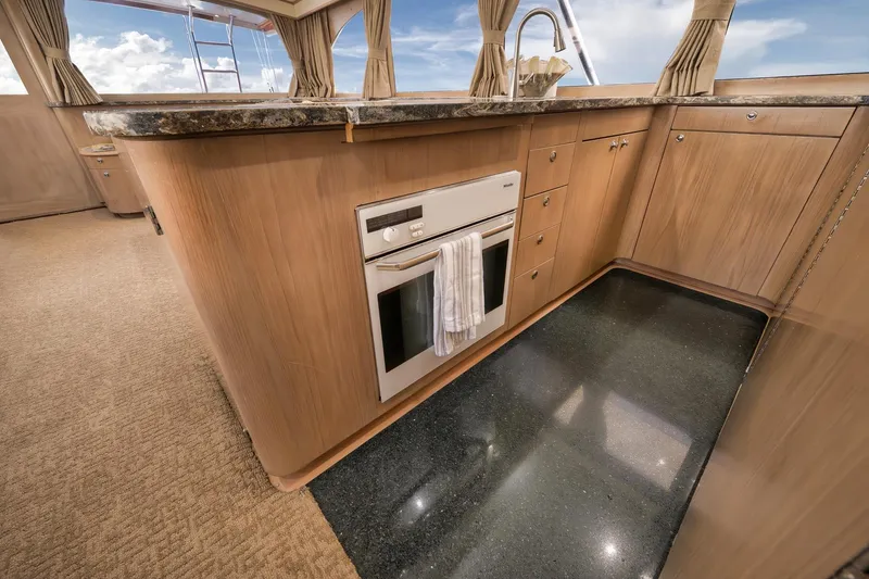 Slide: The Image of Luxurious 1993 Merritt Sportfish yacht kitchen with wood cabinetry and modern appliances. - 29