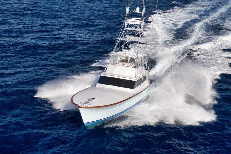 Slide: The Image of 1993 Merritt Sportfish yacht cruising swiftly on open ocean waters. - 3