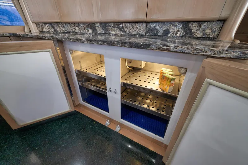 Slide: The Image of Open cabinet with granite countertop on a 1993 Merritt Sportfish boat. - 33