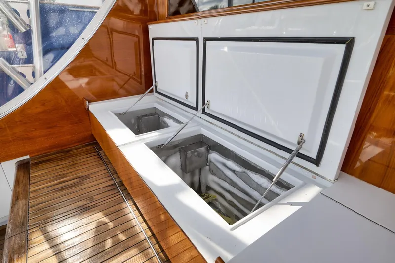 Slide: The Image of Open storage compartments on 1993 Merritt Sportfish boat with wooden deck. - 38