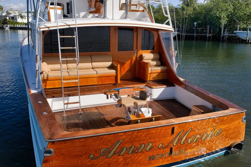 Slide: The Image of 1993 Merritt Sportfish boat with wooden deck and seating, docked in a serene waterway. - 40