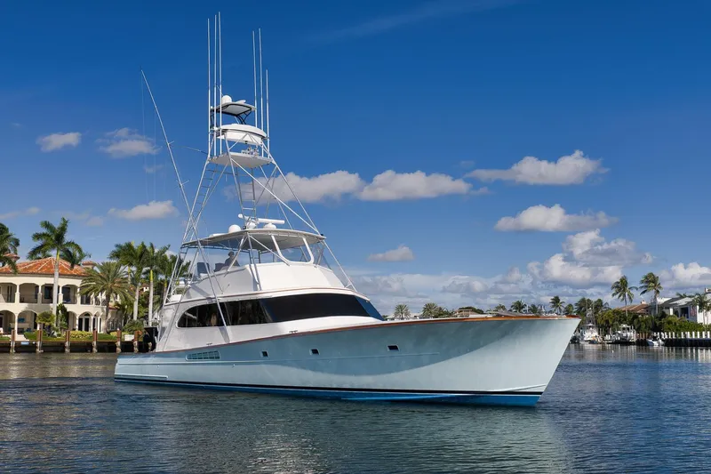 Slide: The Image of 1993 Merritt Sportfish yacht on calm water, with palm trees and blue sky background. - 41