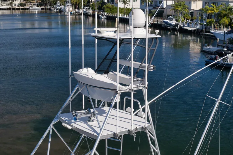 Slide: The Image of 1993 Merritt Sportfish boat tower with radar, docked in a serene marina. - 42