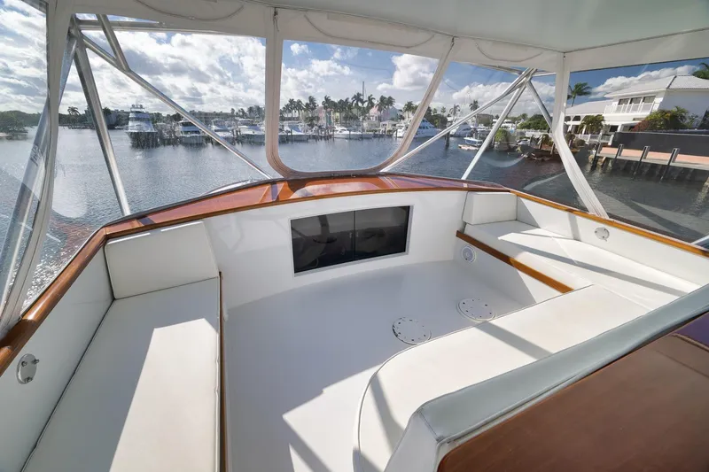 Slide: The Image of 1993 Merritt Sportfish boat interior with white seating and waterfront view. - 47
