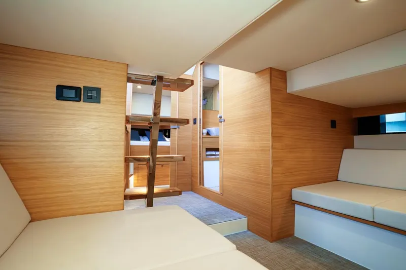 Slide: The Image of 2026 De Antonio Yachts D42 with sunshade, docked by a scenic waterfront. - 12