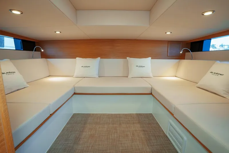 Slide: The Image of 2026 De Antonio Yachts D42 luxury deck with seating and table, docked at marina. - 13
