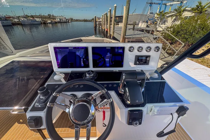 Slide: The Image of Helm of 2026 De Antonio Yachts D42, featuring modern controls and dual displays at a marina. - 24