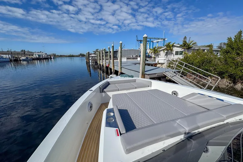Slide: The Image of 2026 De Antonio Yachts D42 docked, featuring spacious deck and modern design under blue sky. - 43