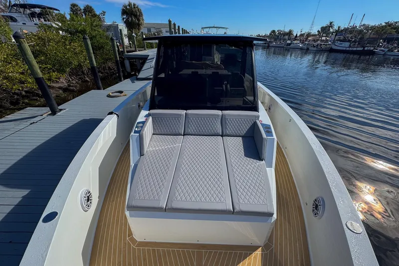 Slide: The Image of 2026 De Antonio Yachts D42 luxury boat with sunbed, docked in a serene marina. - 45