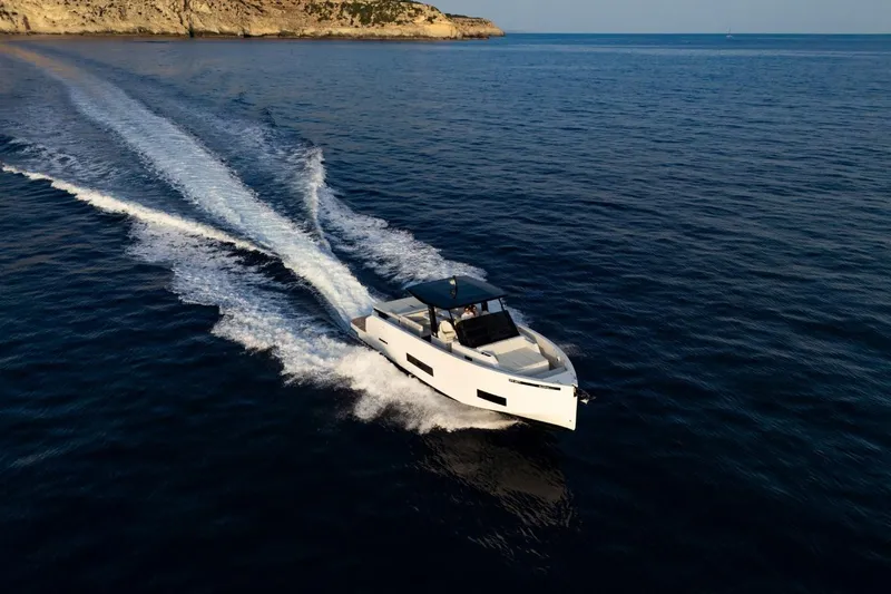 Slide: The Image of 2026 De Antonio Yachts D42 with open engine compartment, showcasing powerful outboard motors. - 6