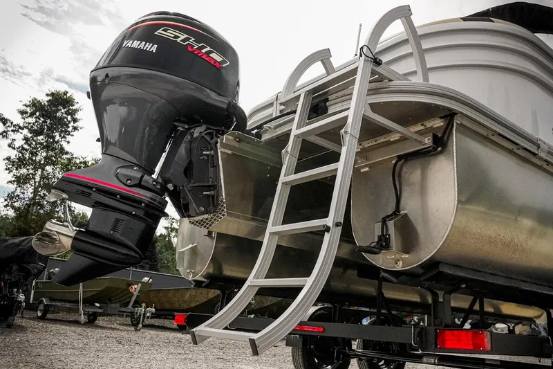 Slide: The Image of 2026 SunCatcher Select 22RC pontoon boat with Yamaha outboard motor and ladder. - 11