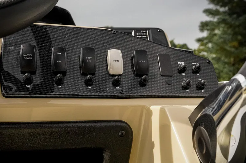 Slide: The Image of Control panel of 2026 SunCatcher Select 22RC boat with various switches and knobs. - 21
