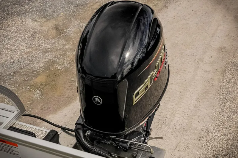 Slide: The Image of 2026 SunCatcher Select 22RC boat engine, Yamaha outboard, on gravel surface. - 25
