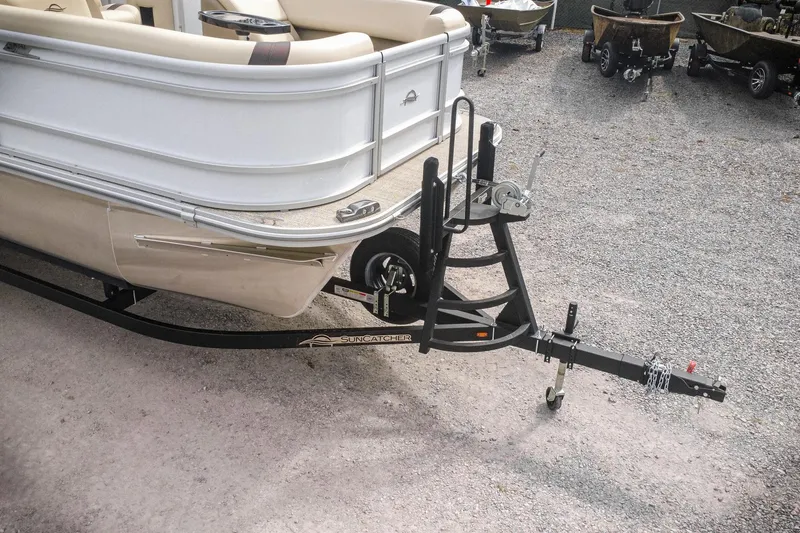 Slide: The Image of 2026 SunCatcher Select 22RC boat on trailer, parked on gravel surface. - 35