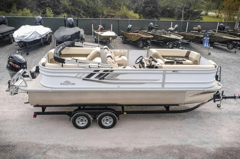 Slide: The Image of 2026 SunCatcher Select 22RC pontoon boat on trailer, parked in a lot. - 4