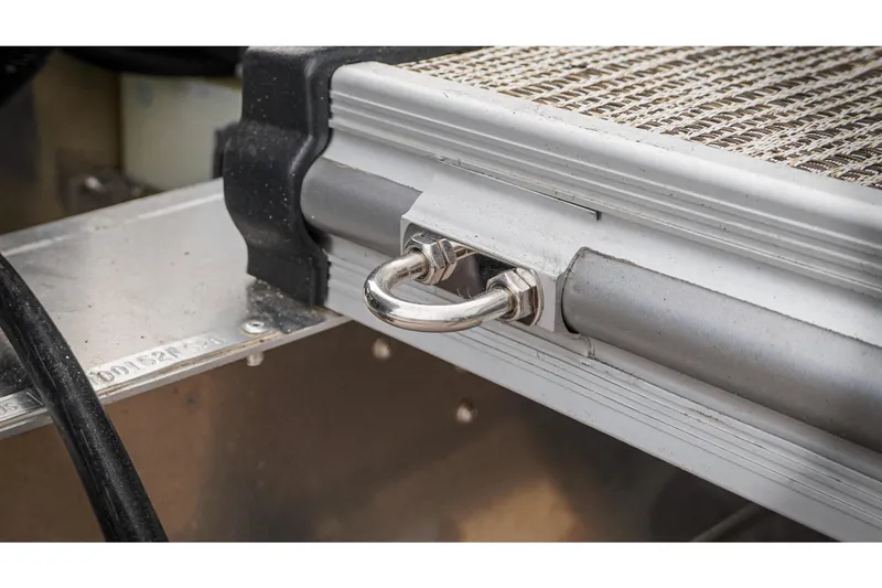 Slide: The Image of Close-up of 2026 SunCatcher Select 22RC boat detail, featuring a metal latch and textured surface. - 46