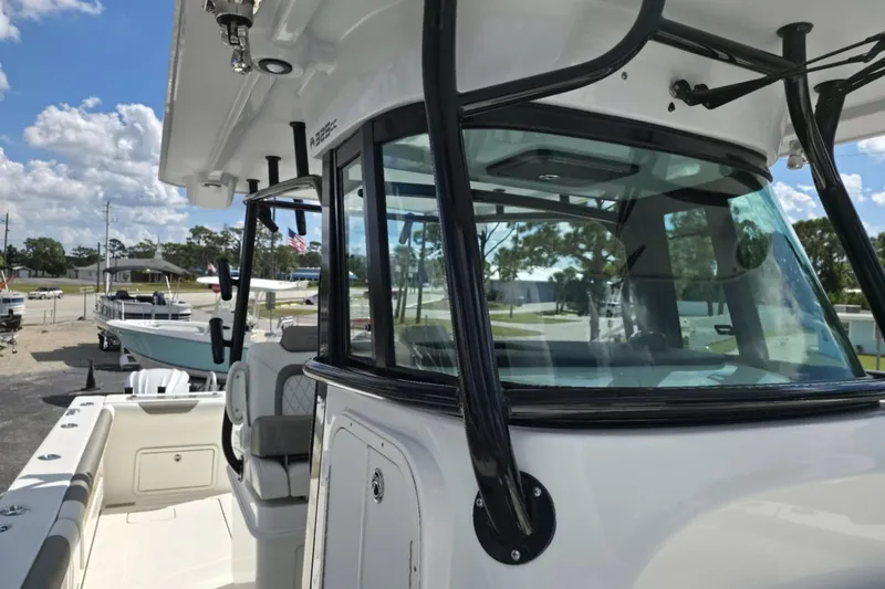 Slide: The Image of 2023 World Cat 325 CC boat, close-up of helm and seating area, outdoors. - 17