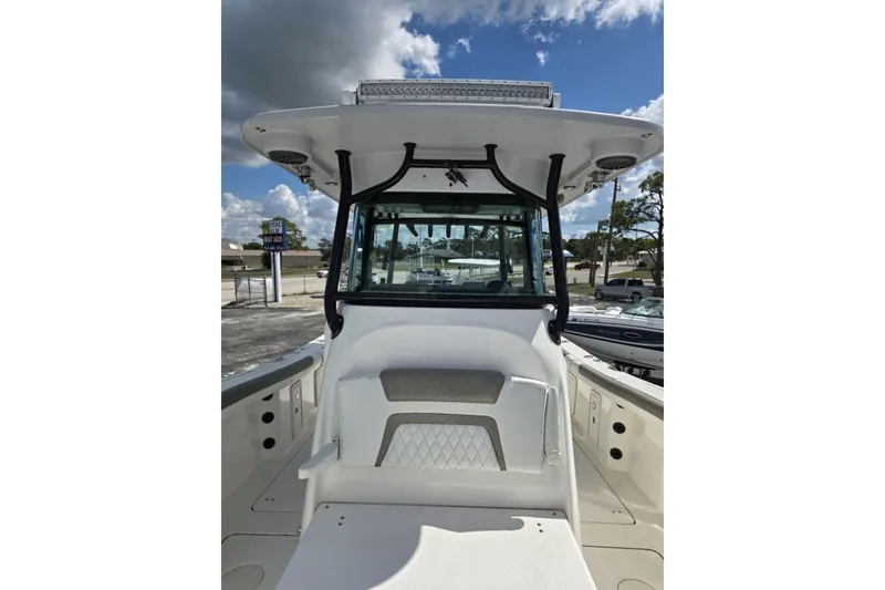 Slide: The Image of 2023 World Cat 325 CC boat with center console and T-top under a cloudy sky. - 18