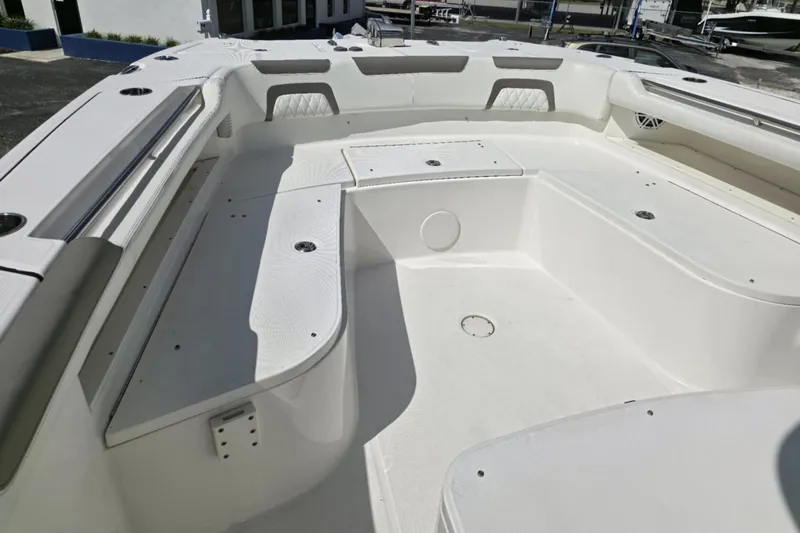 Slide: The Image of 2023 World Cat 325 CC boat interior, featuring spacious seating and storage compartments. - 24