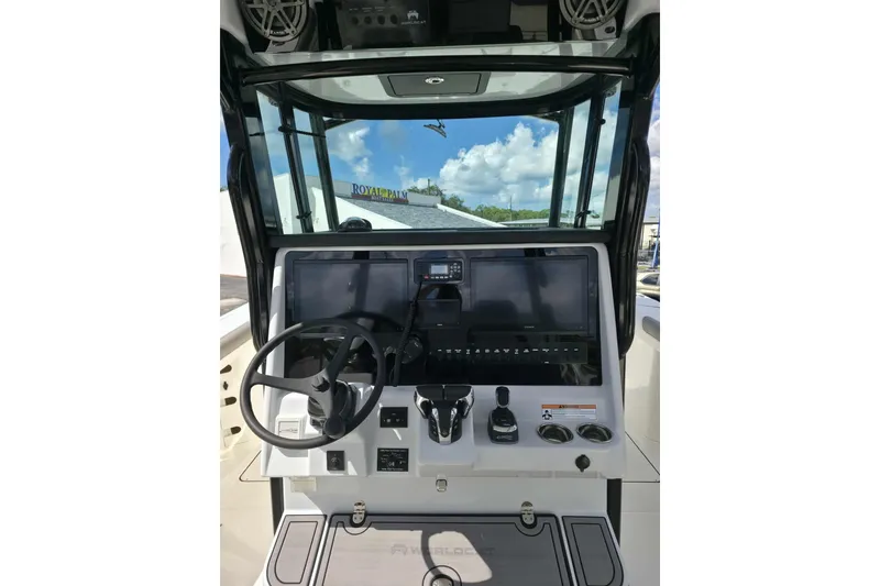 Slide: The Image of 2023 World Cat 325 CC helm with steering wheel and navigation controls. - 25