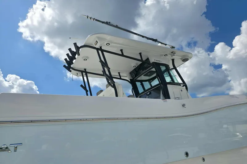 Slide: The Image of 2023 World Cat 325 CC boat against a cloudy blue sky. - 27