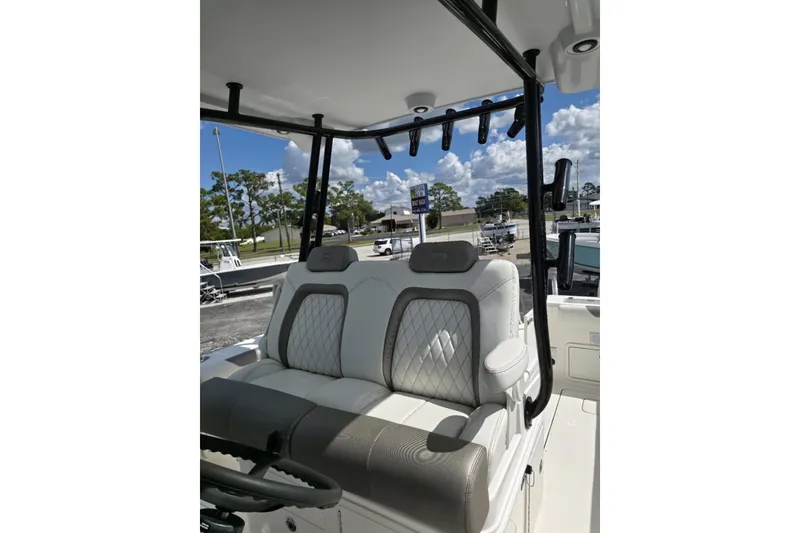 Slide: The Image of 2023 World Cat 325 CC boat interior with plush seating and rod holders. - 28