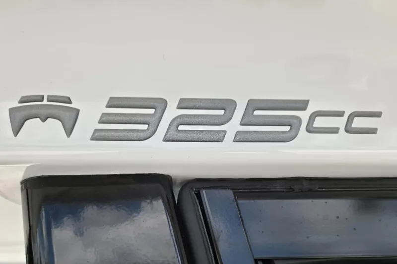 Slide: The Image of World Cat 325 CC 2023 model emblem on a white surface. - 29