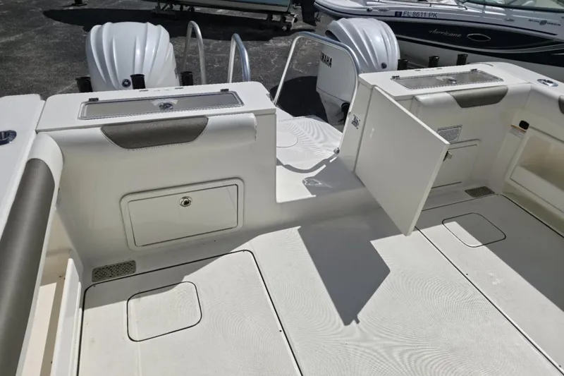 Slide: The Image of 2023 World Cat 325 CC boat interior with storage compartments and Yamaha engines. - 30