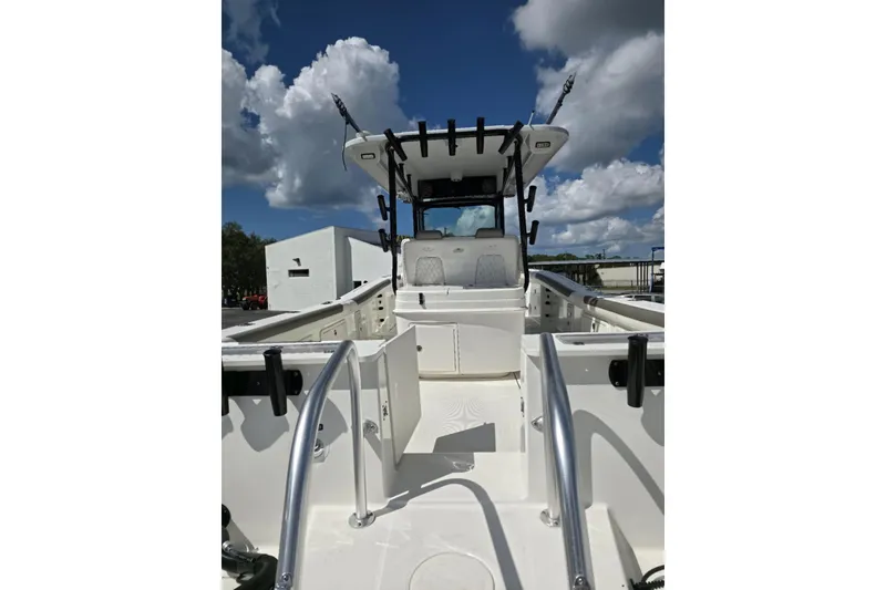 Slide: The Image of 2023 World Cat 325 CC boat, center console, sleek design, under blue sky. - 31
