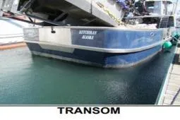 Slide: The Image of Transom view of 1979 Custom Longliner 58 boat docked in water. - 12