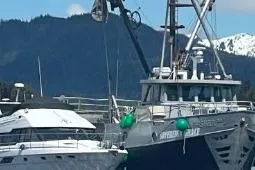 Slide: The Image of 1979 Custom Longliner 58 boat docked with scenic mountain backdrop. - 5