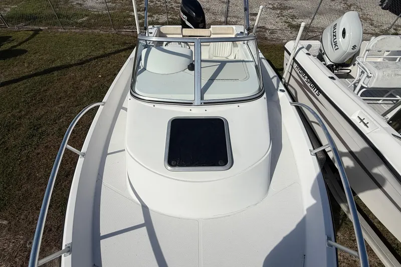Slide: The Image of 2005 Mako 215 Walk Around boat, top view, showcasing deck and windshield. - 19