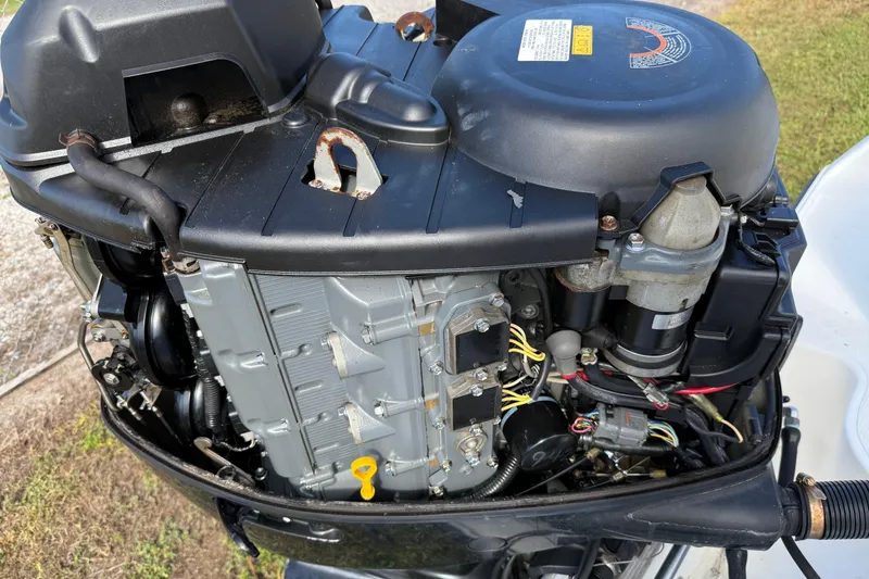 Slide: The Image of Close-up of a 2005 Mako 215 Walk Around boat engine, showcasing mechanical components. - 6