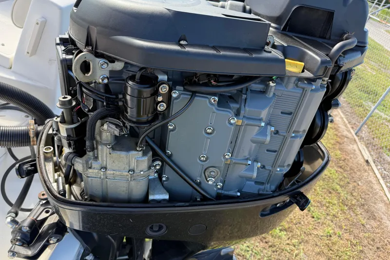 Slide: The Image of Close-up of a 2005 Mako 215 Walk Around boat engine, showcasing detailed components. - 8