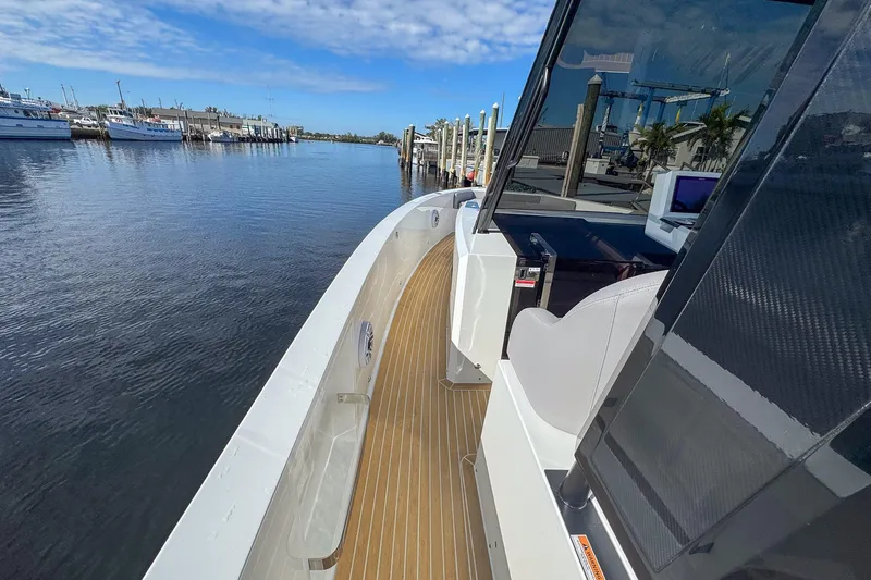 Slide: The Image of 2026 De Antonio Yachts D42 docked, showcasing sleek design and spacious deck. - 20