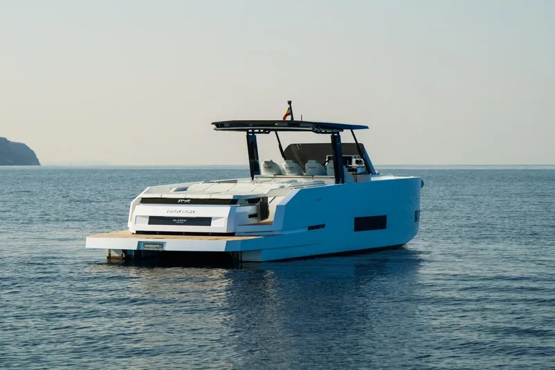 Slide: The Image of 2026 De Antonio Yachts D42 docked, showcasing sleek design and spacious deck. - 4