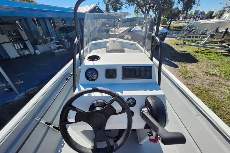 Slide: The Image of 2026 Lowe Roughneck 1860CC boat console with steering wheel and controls. - 11