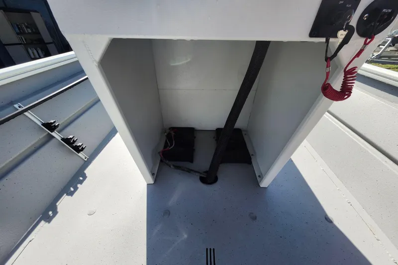 Slide: The Image of Interior view of a 2026 Lowe Roughneck 1860CC boat console with wiring and controls. - 12