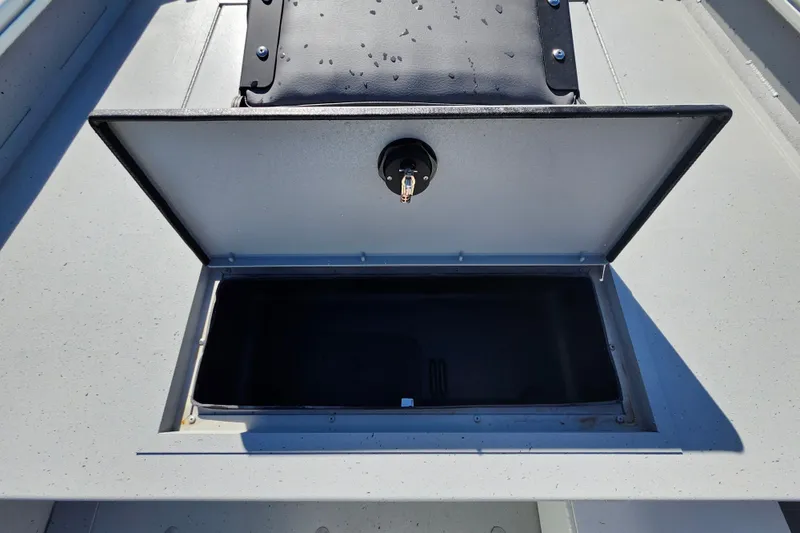 Slide: The Image of Open storage compartment on 2026 Lowe Roughneck 1860CC boat, showing interior space. - 14