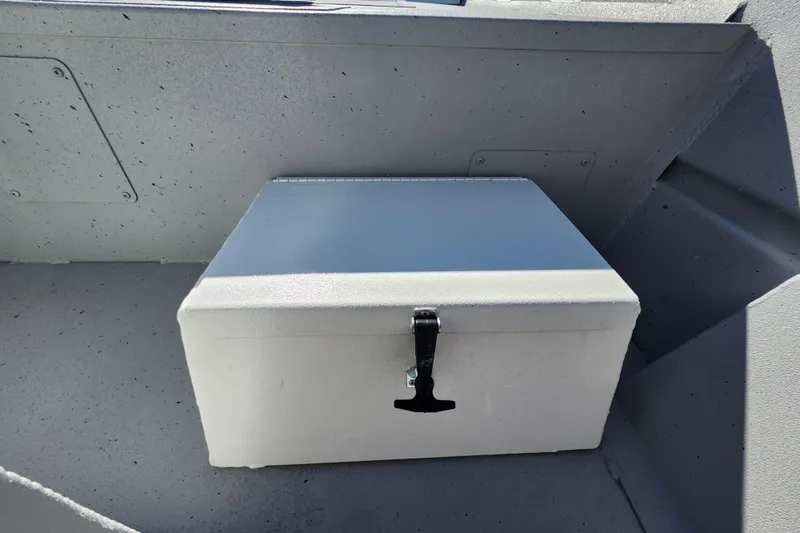 Slide: The Image of Storage compartment on 2026 Lowe Roughneck 1860CC boat, featuring a secure latch. - 15